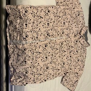 Pink polo with black dotes.